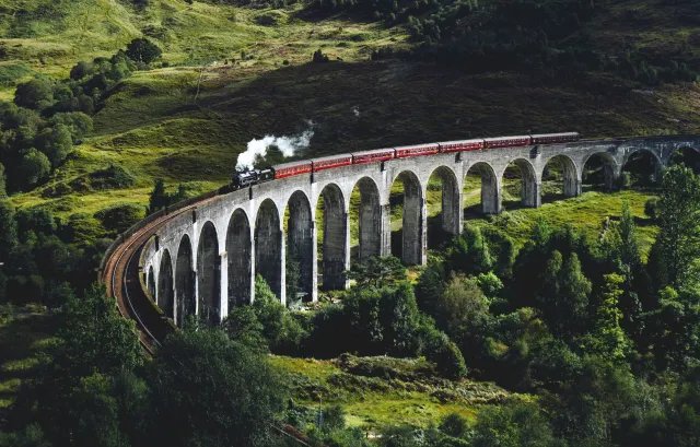 A steam train crossing the Glenfinnan Viaduct in the Scottish Highlands