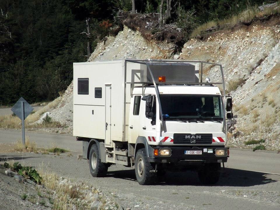 A white expedition truck motorhome parked on a gravel road in Patagonia